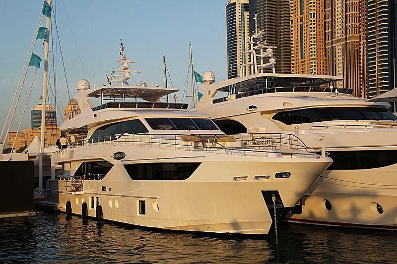 a couple of white yachts in a harbor aboard AMORE Yacht for Sale