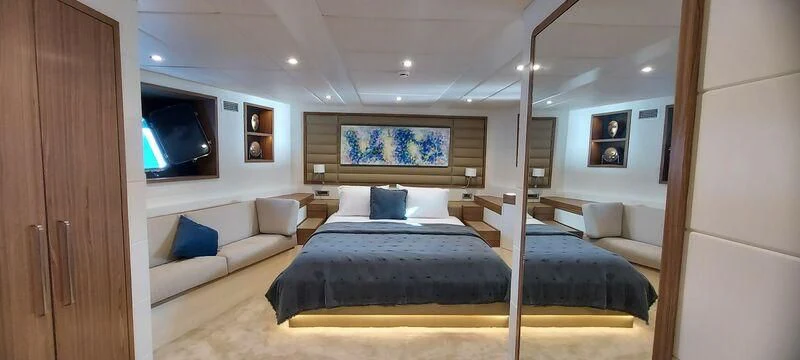a bedroom with a bed and a television aboard DEEP WATER Yacht for Charter