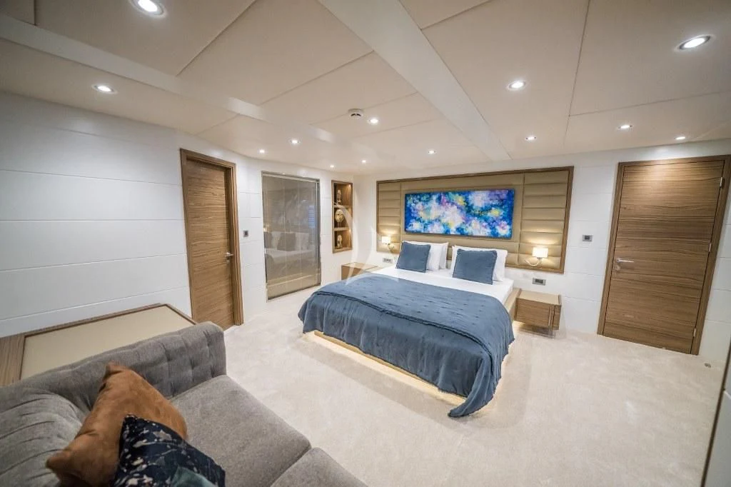 a bedroom with a bed and a couch aboard DEEP WATER Yacht for Charter