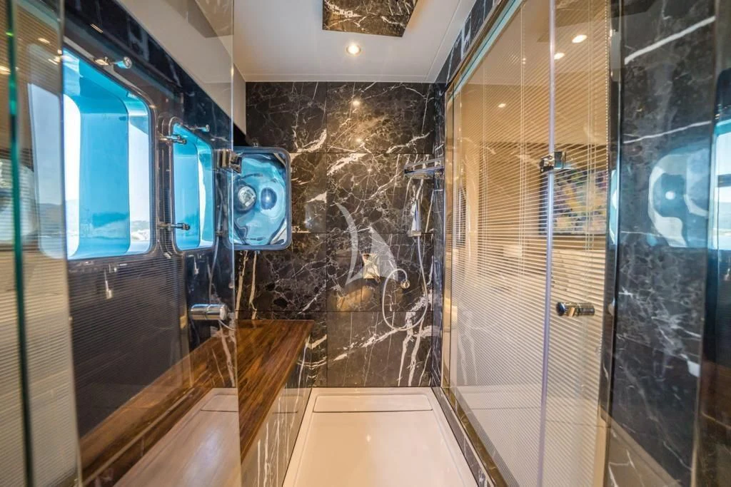 a bathroom with a glass shower aboard DEEP WATER Yacht for Charter