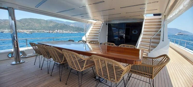 a deck with chairs and tables on it aboard DEEP WATER Yacht for Charter