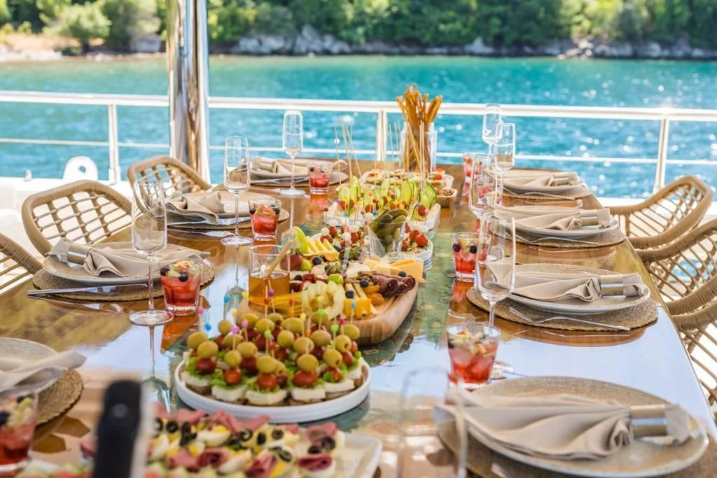 a table set with food and drinks aboard DEEP WATER Yacht for Charter
