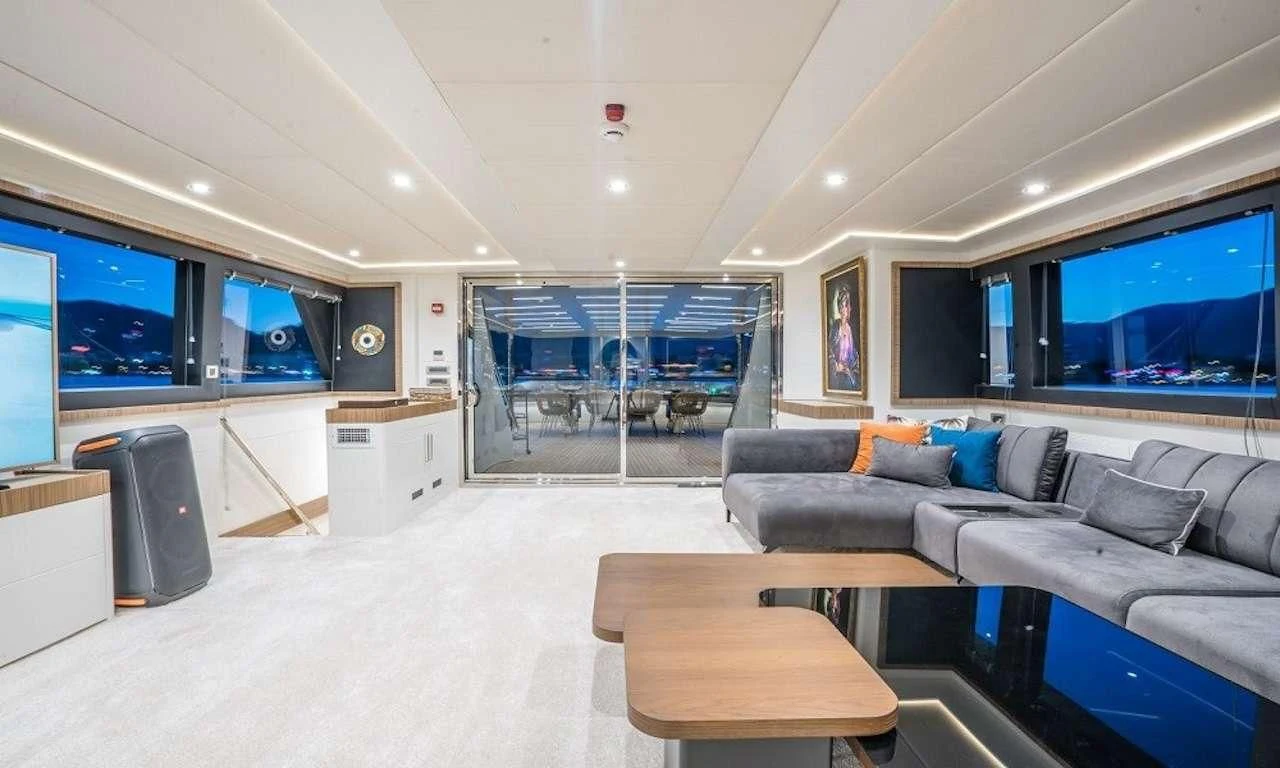 a living room with a large window aboard DEEP WATER Yacht for Charter