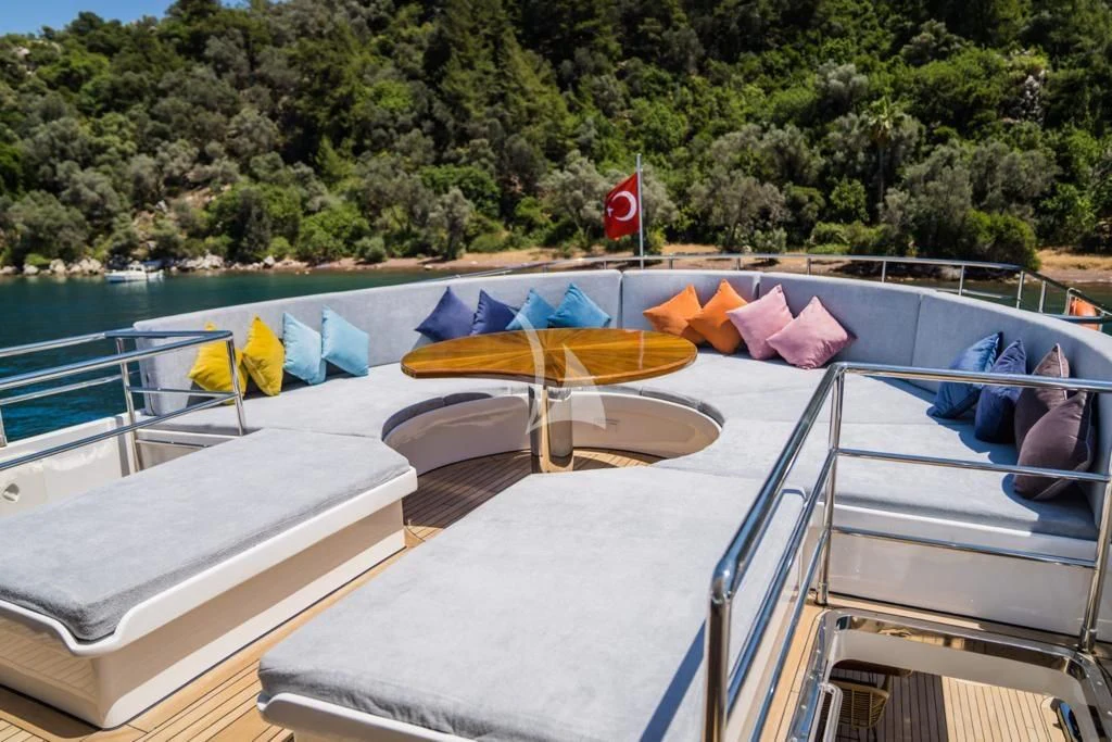 a deck with a pool and trees in the background aboard DEEP WATER Yacht for Charter