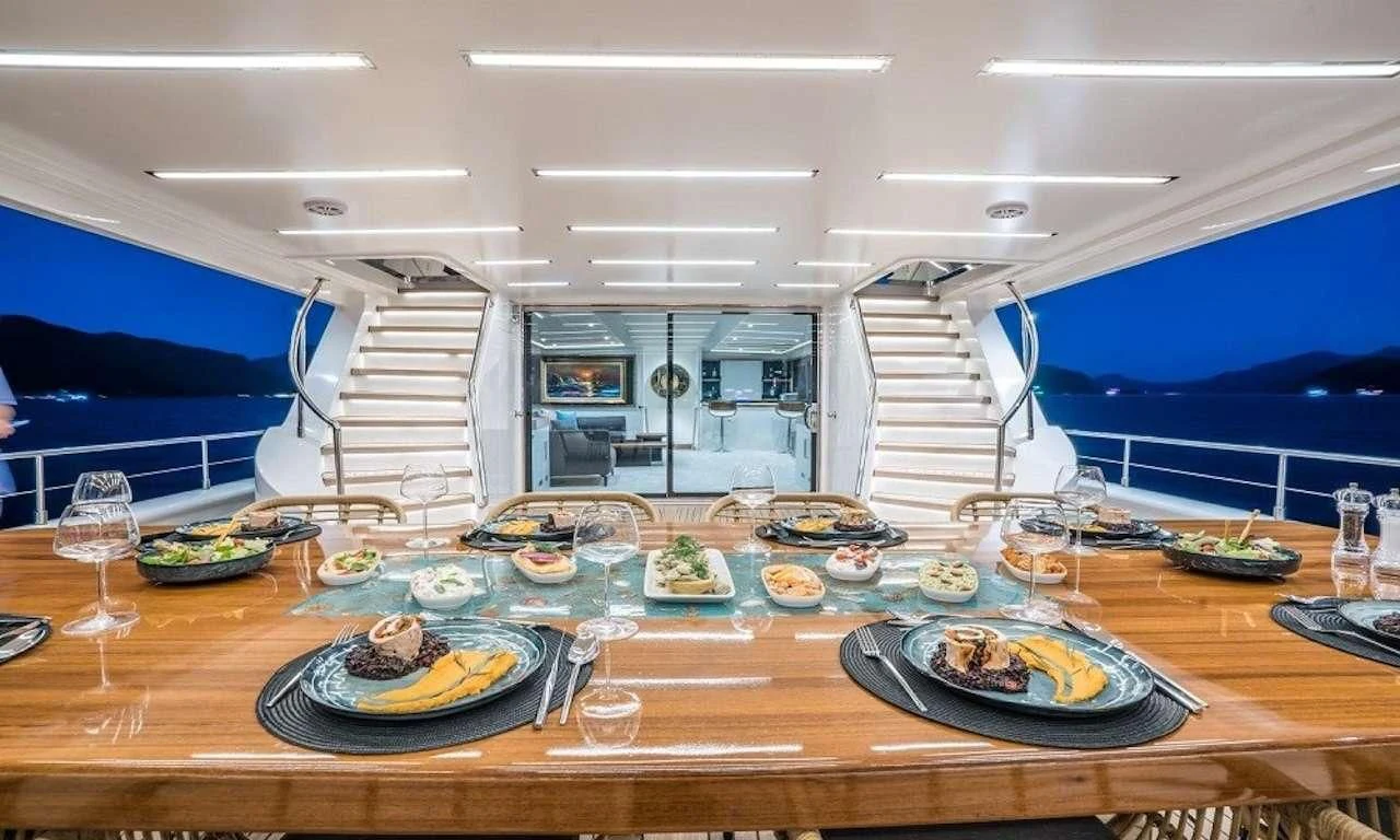 a table with plates and food on it aboard DEEP WATER Yacht for Charter
