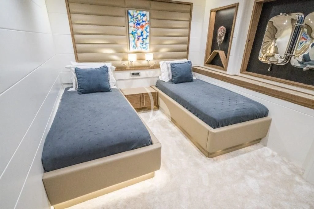 a room with a bed and a mirror aboard DEEP WATER Yacht for Charter
