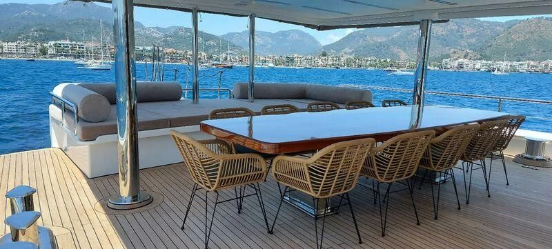 a group of chairs on a deck overlooking a large body of water aboard DEEP WATER Yacht for Charter