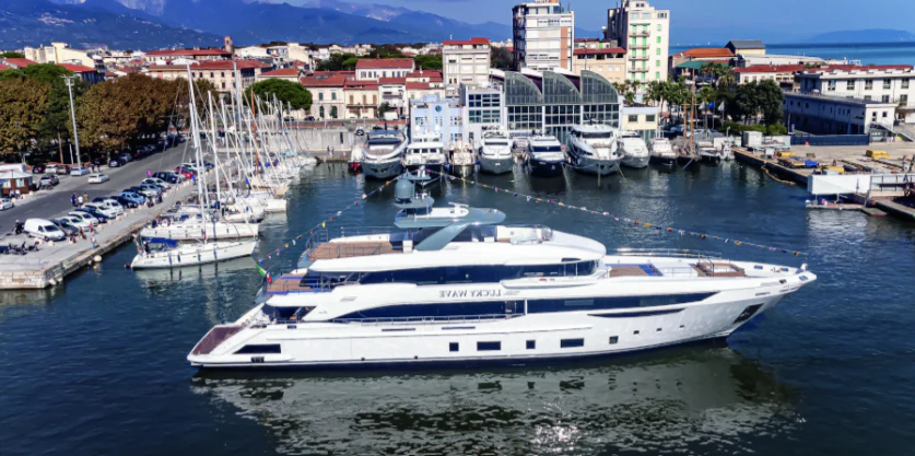a large white boat in a harbor aboard CASA Yacht for Sale