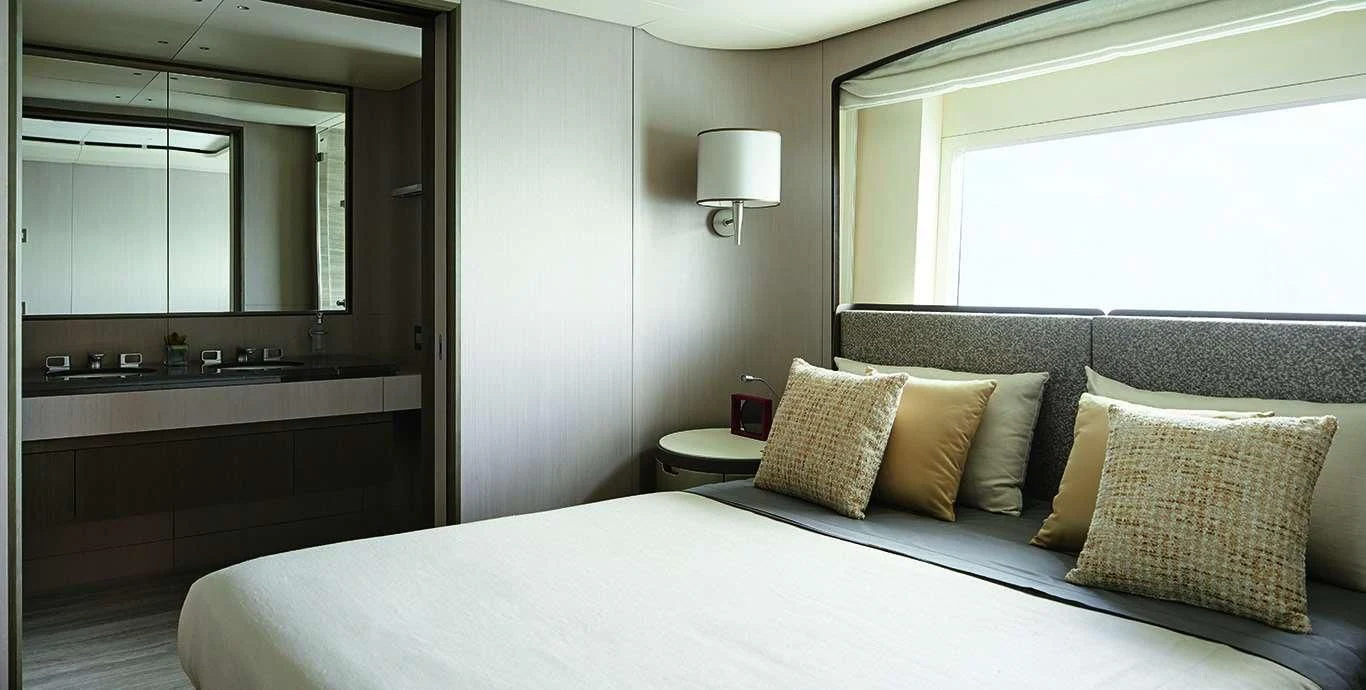 a bed with pillows on it aboard CASA Yacht for Sale