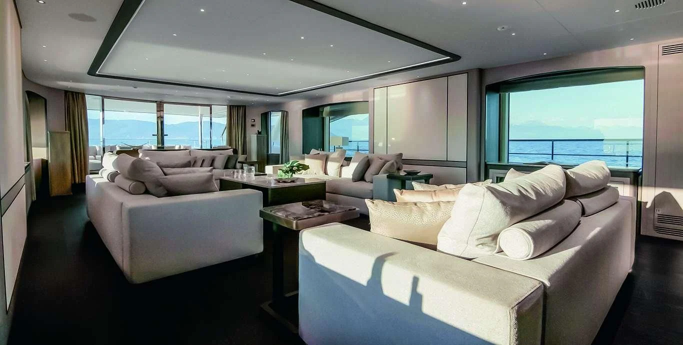 a room with a couch and a table and a large window aboard CASA Yacht for Sale