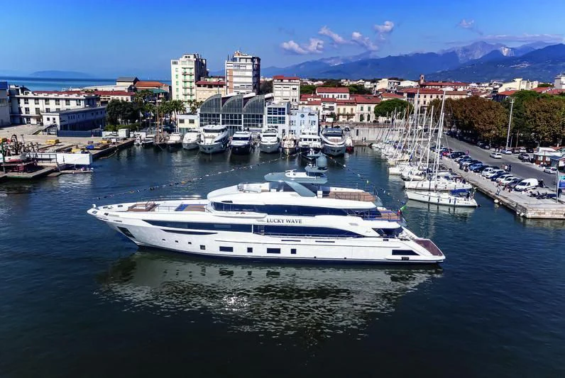 a large white boat in a harbor aboard CASA Yacht for Sale