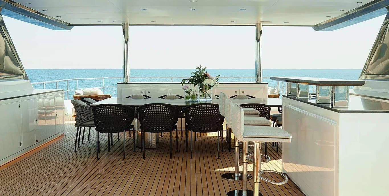 a large room with a table and chairs aboard CASA Yacht for Sale