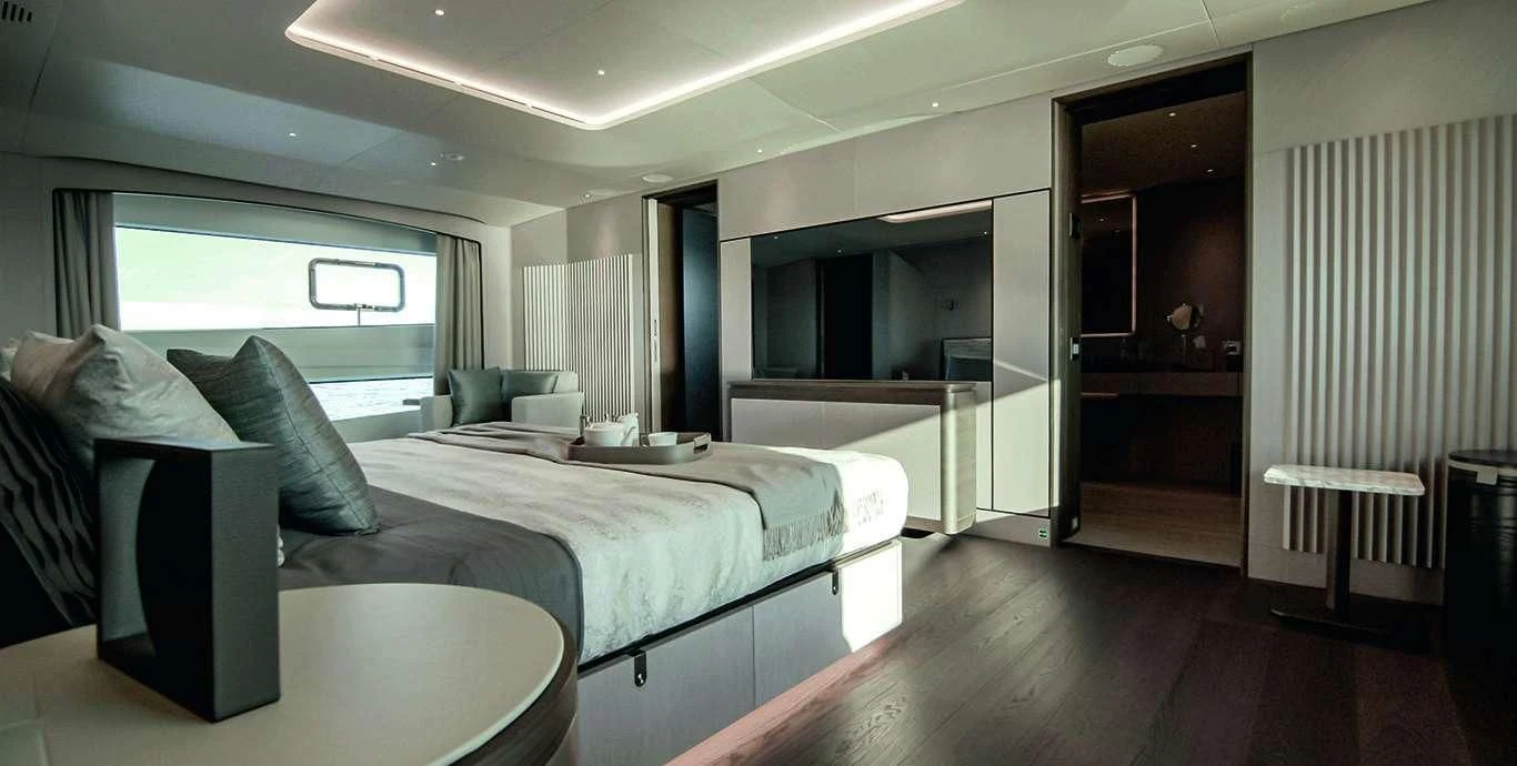 a room with a bed and a couch aboard CASA Yacht for Sale