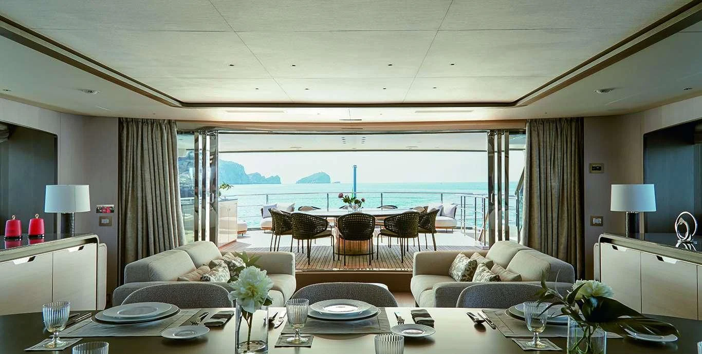 a living room with a large balcony aboard CASA Yacht for Sale