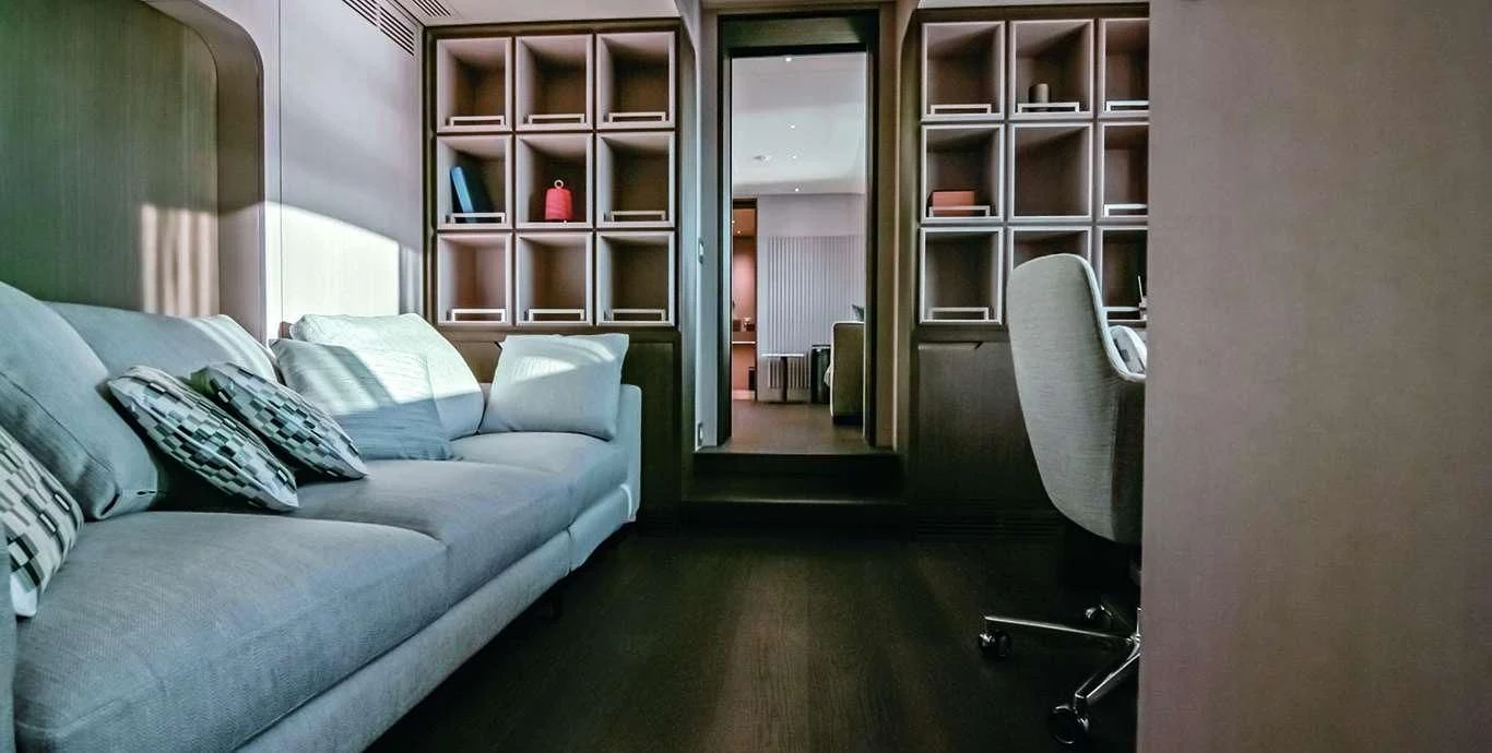 a living room with a couch and a glass door aboard CASA Yacht for Sale