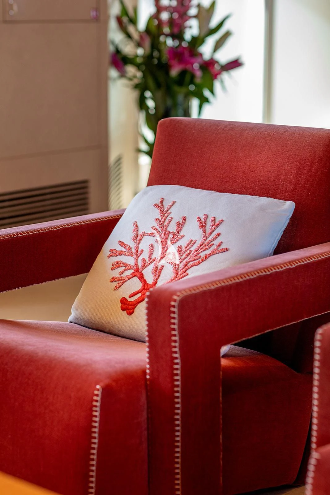 a red chair with a floral pattern aboard LUISA Yacht for Charter