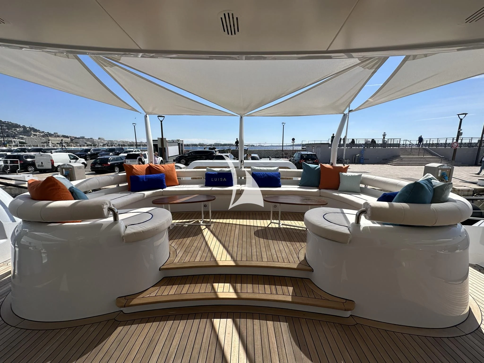 a lounge area with chairs and a large body of water in the background aboard LUISA Yacht for Charter