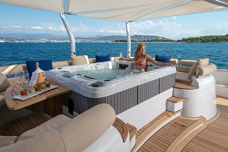 a person lying on a lounge chair on a boat aboard LUISA Yacht for Charter