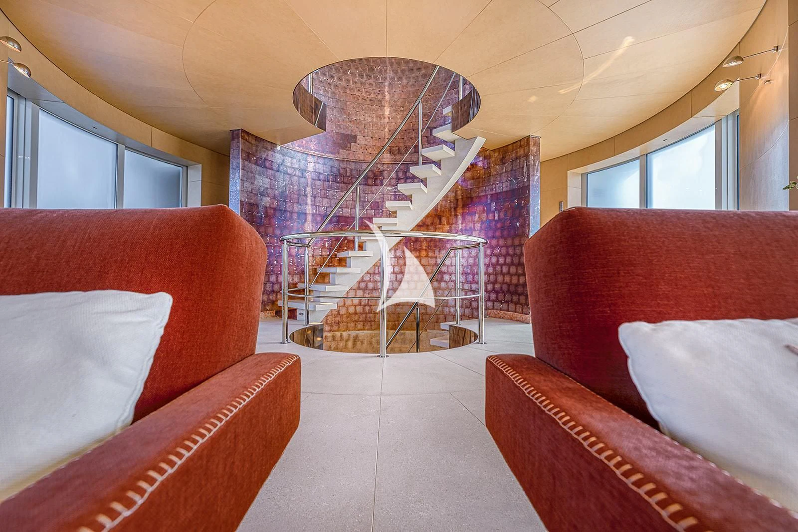 a room with red couches and a ferris wheel aboard LUISA Yacht for Charter