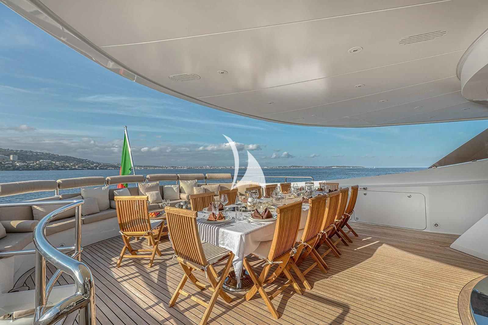 a room with tables and chairs and a view of the ocean aboard LUISA Yacht for Charter