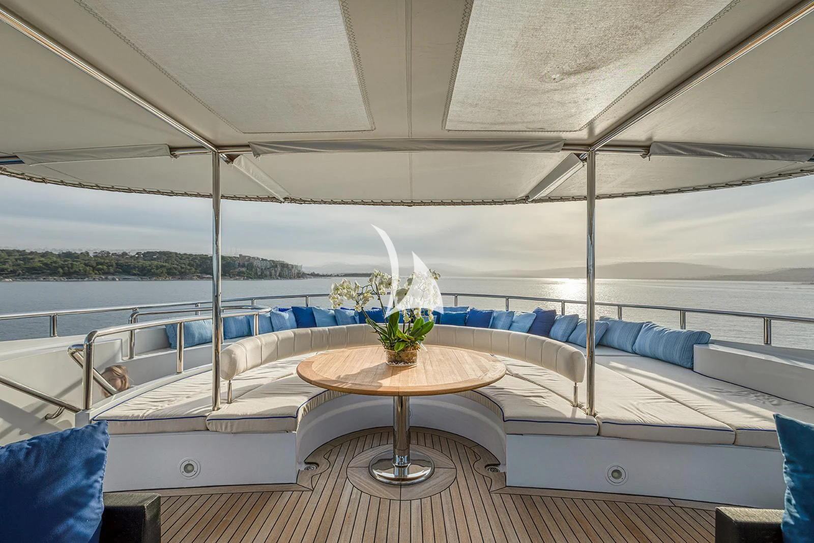 a boat with a table and a plant on the side aboard LUISA Yacht for Charter