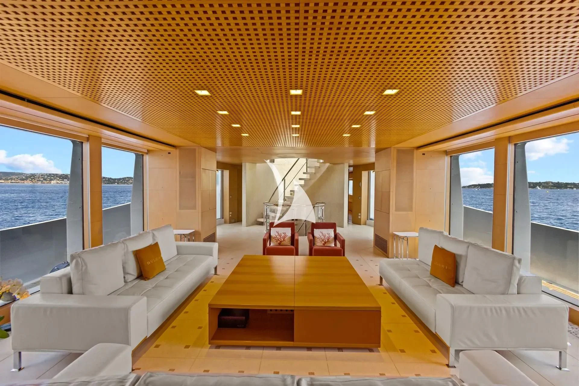 a living room with a table and couches aboard LUISA Yacht for Charter