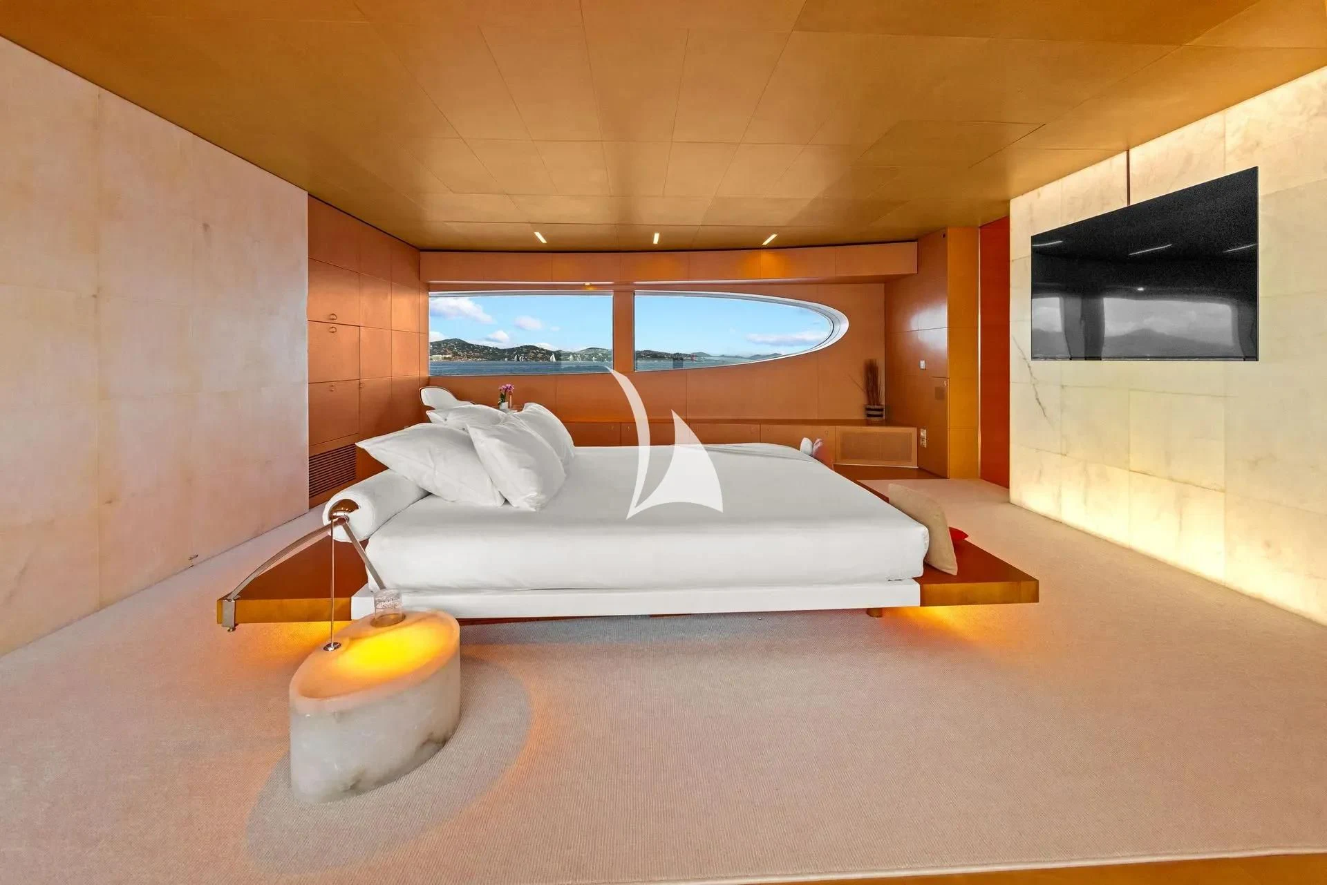 a bedroom with a bed and a television aboard LUISA Yacht for Charter