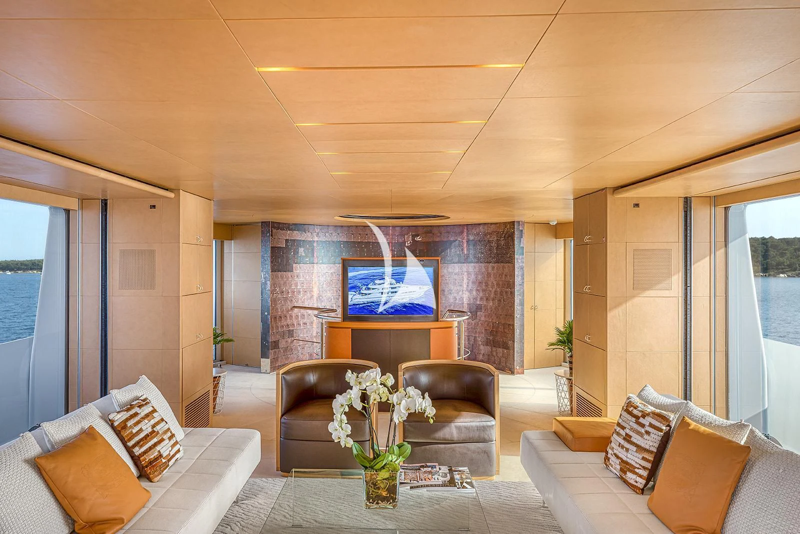 a living room with a leather couch and a fireplace aboard LUISA Yacht for Charter