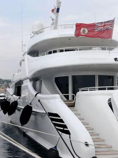 a boat with a flag on the front aboard LUISA Yacht for Charter