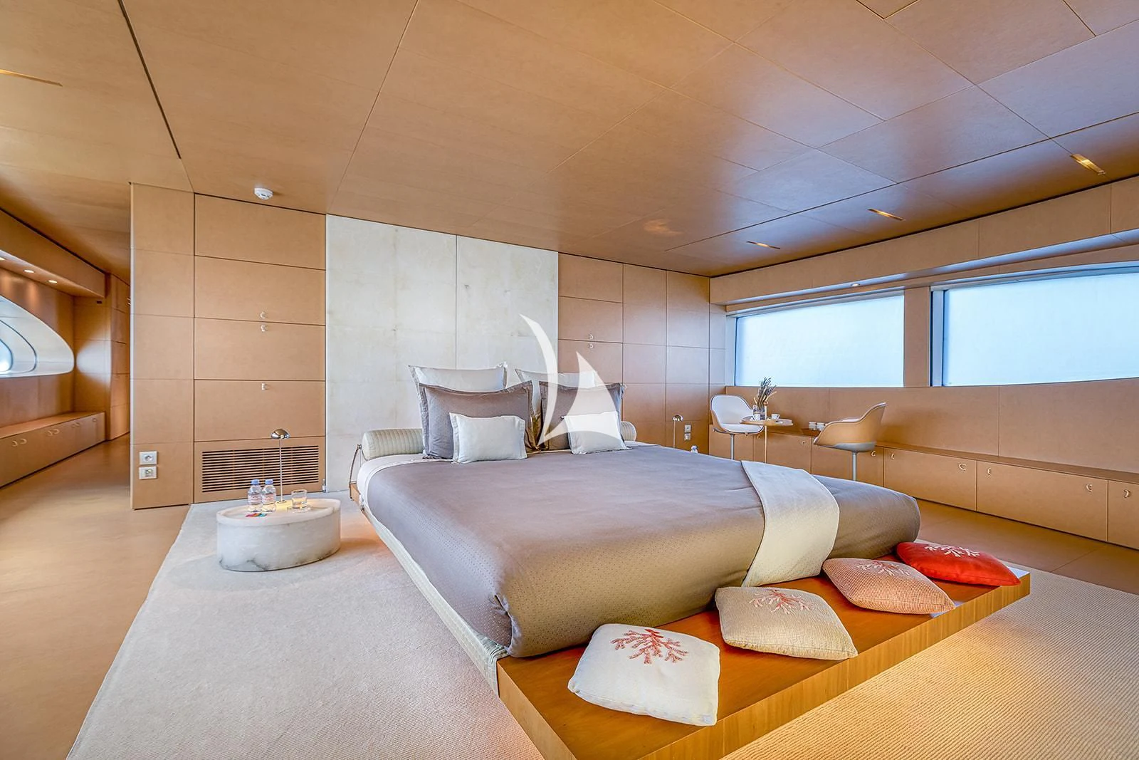 a room with a bed and a table aboard LUISA Yacht for Charter