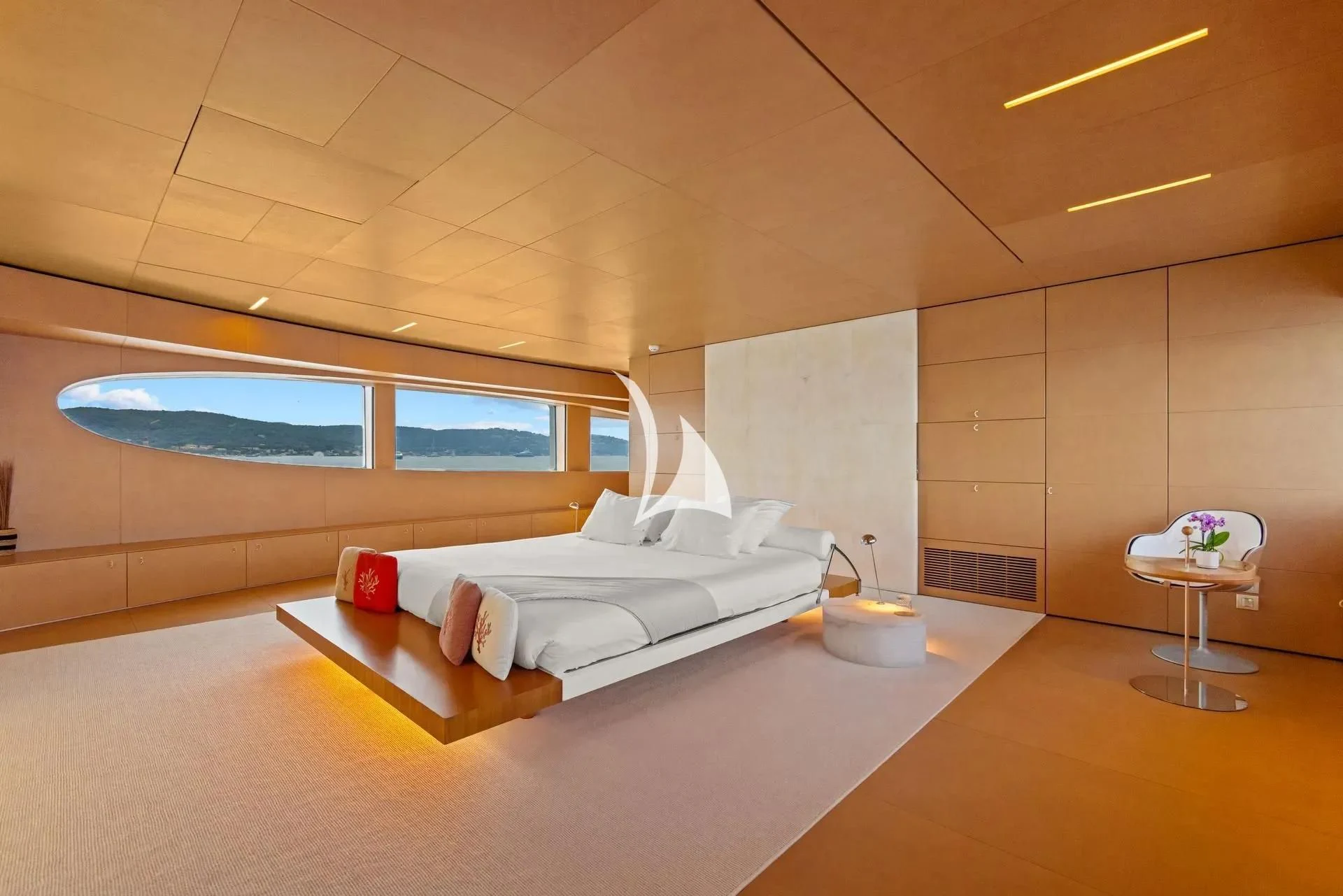a room with a bed and a table aboard LUISA Yacht for Charter