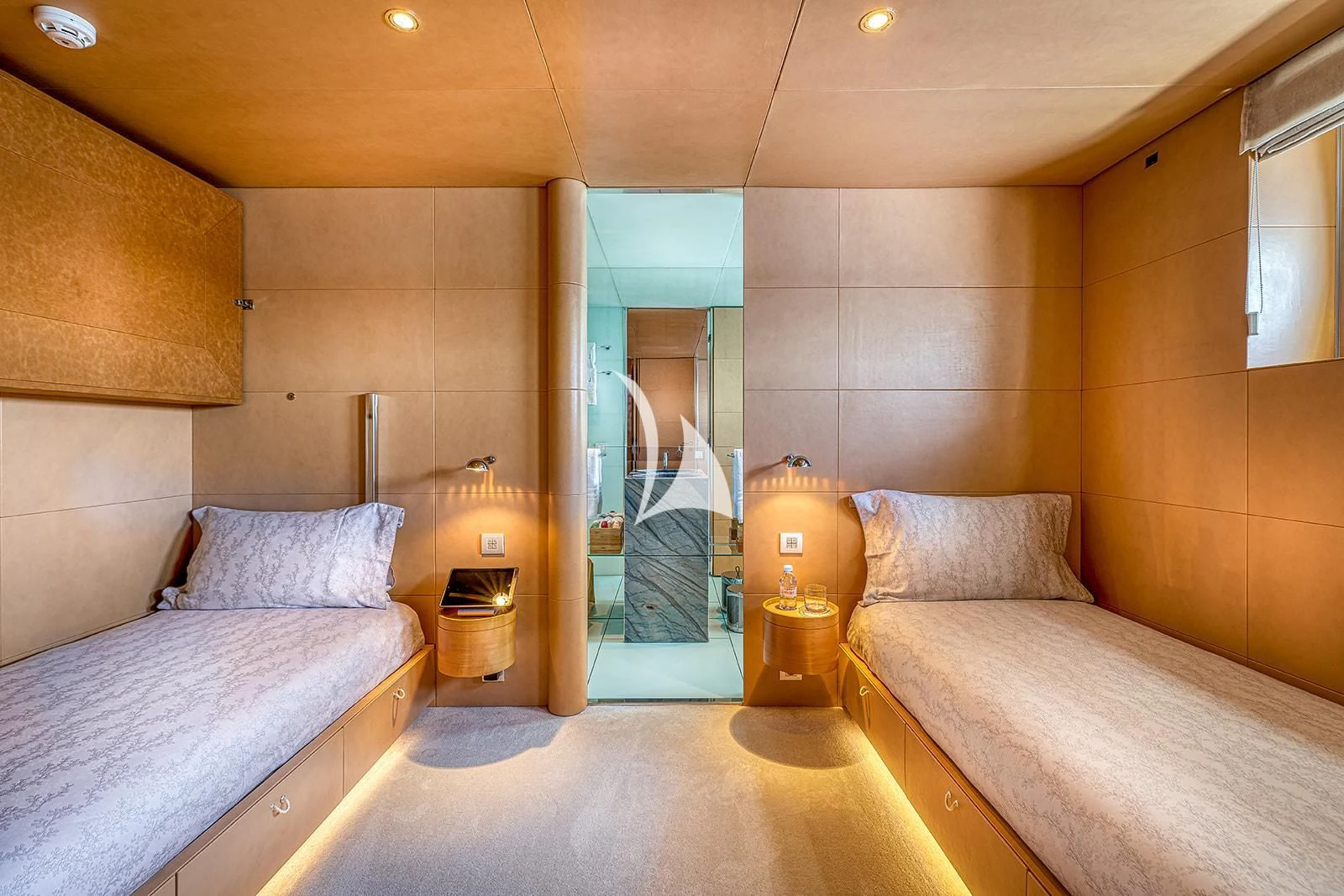 a bedroom with a bed and a mirror aboard LUISA Yacht for Charter