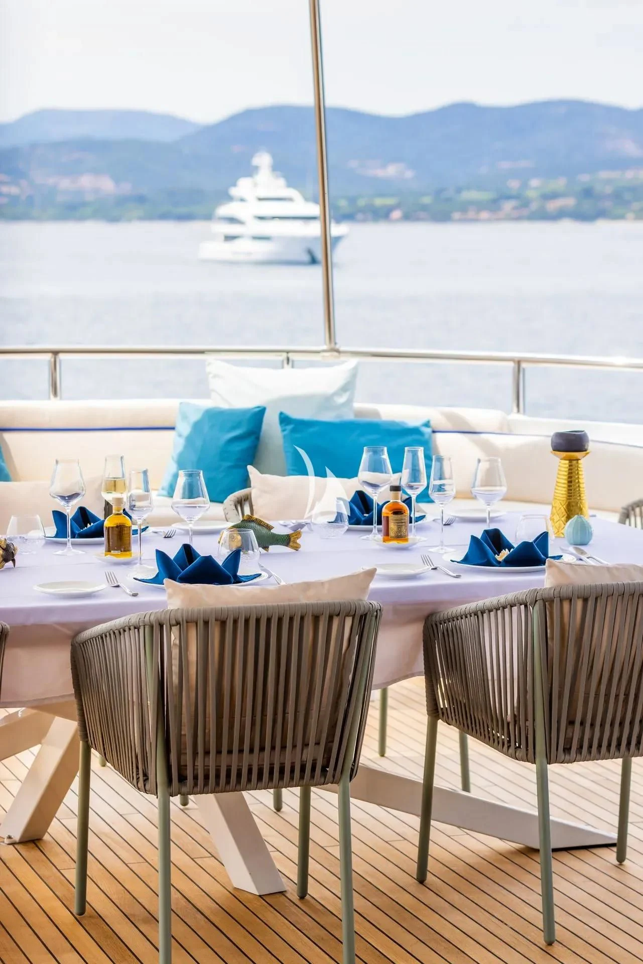 a table with chairs and a view of the ocean aboard LUISA Yacht for Charter