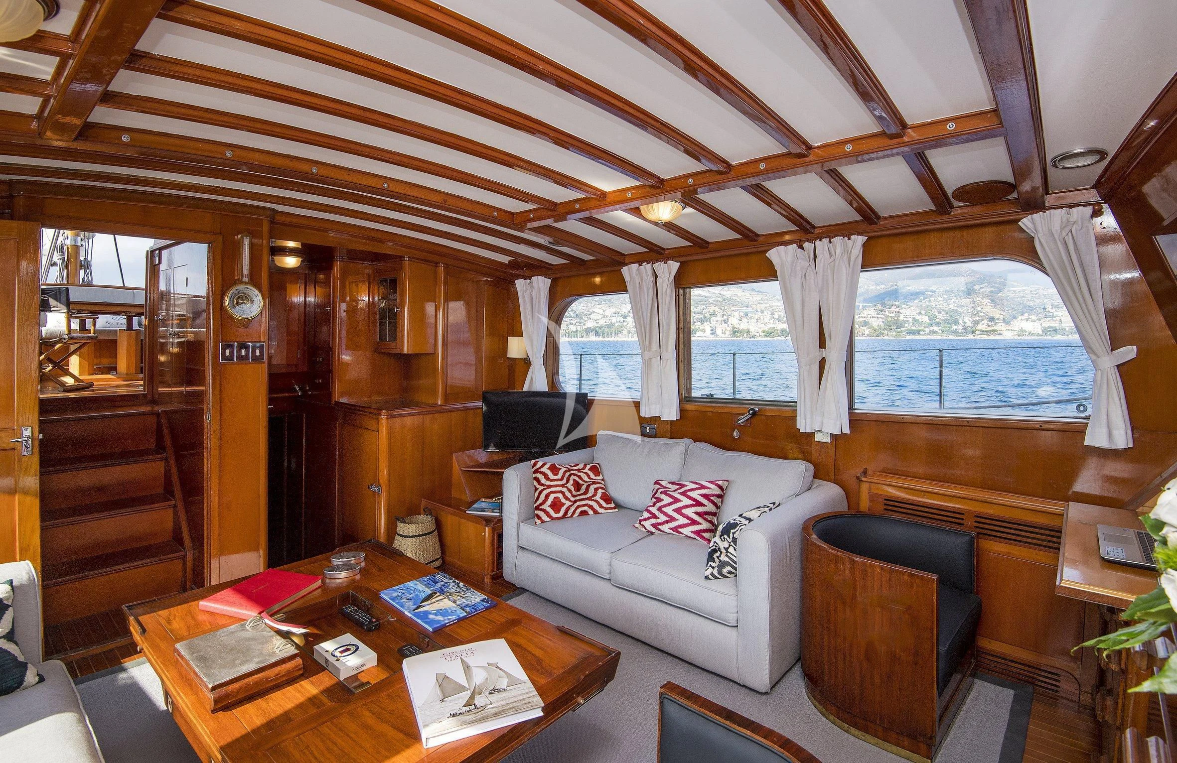 a living room with a couch and a table aboard SEA PRINCE Yacht for Sale