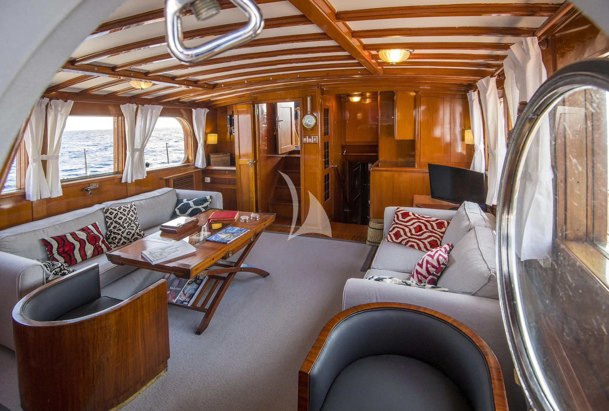 a living room with a couch and a table aboard SEA PRINCE Yacht for Sale