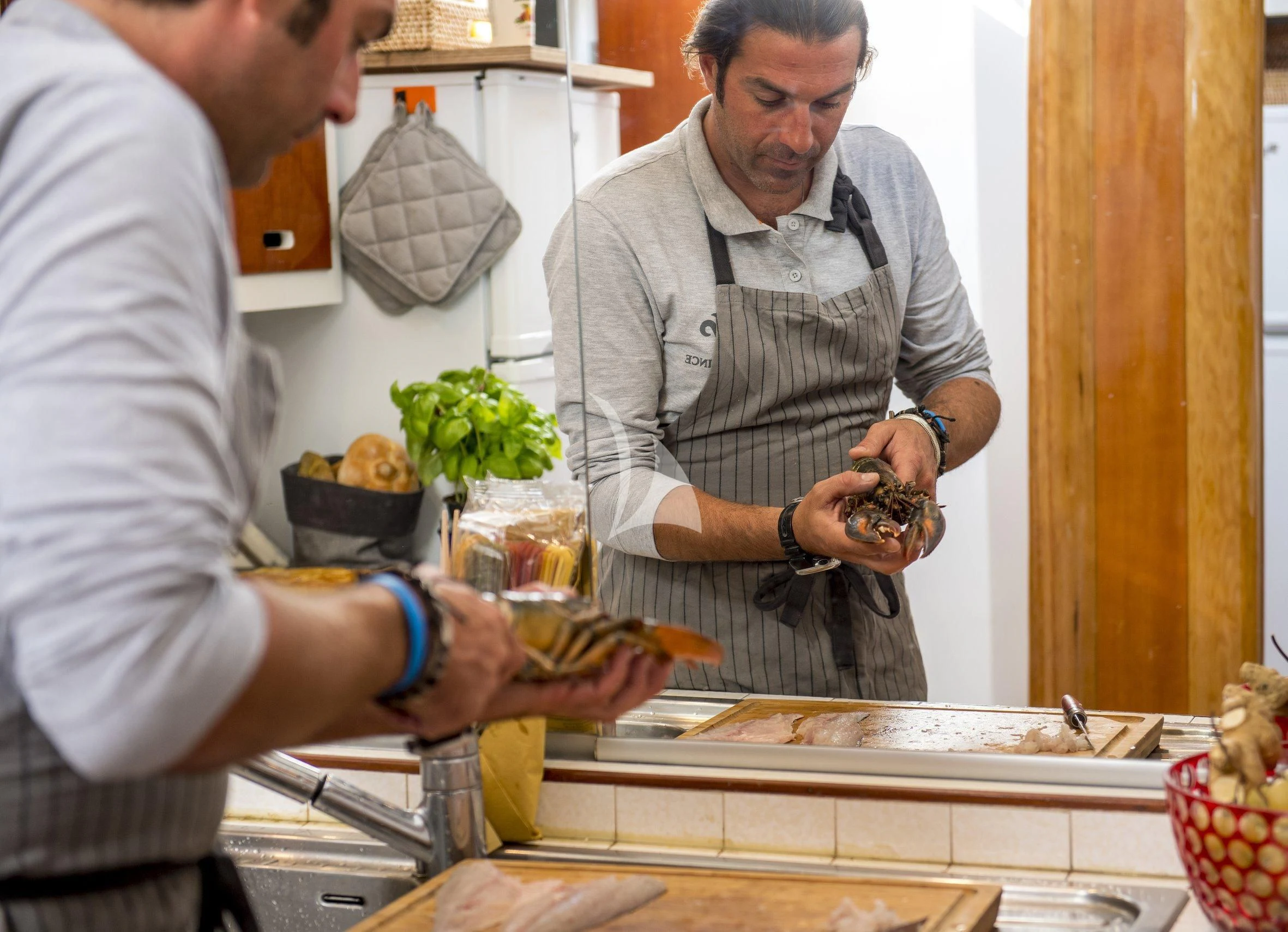 a couple of men preparing food aboard SEA PRINCE Yacht for Sale