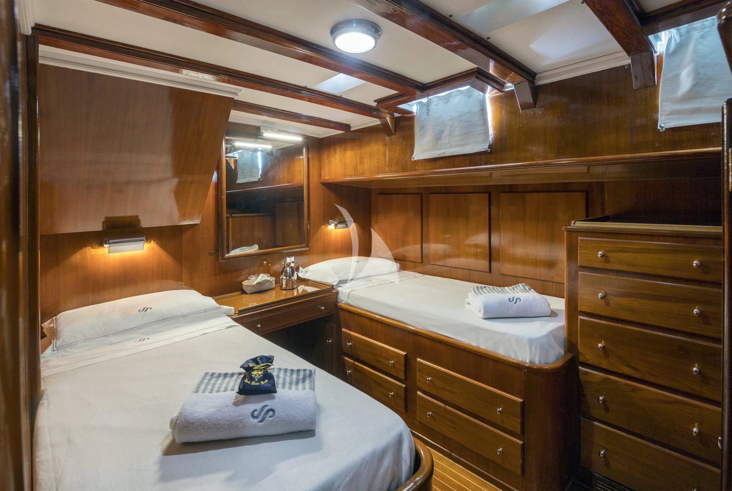 a room with wooden cabinets and a bed aboard SEA PRINCE Yacht for Sale