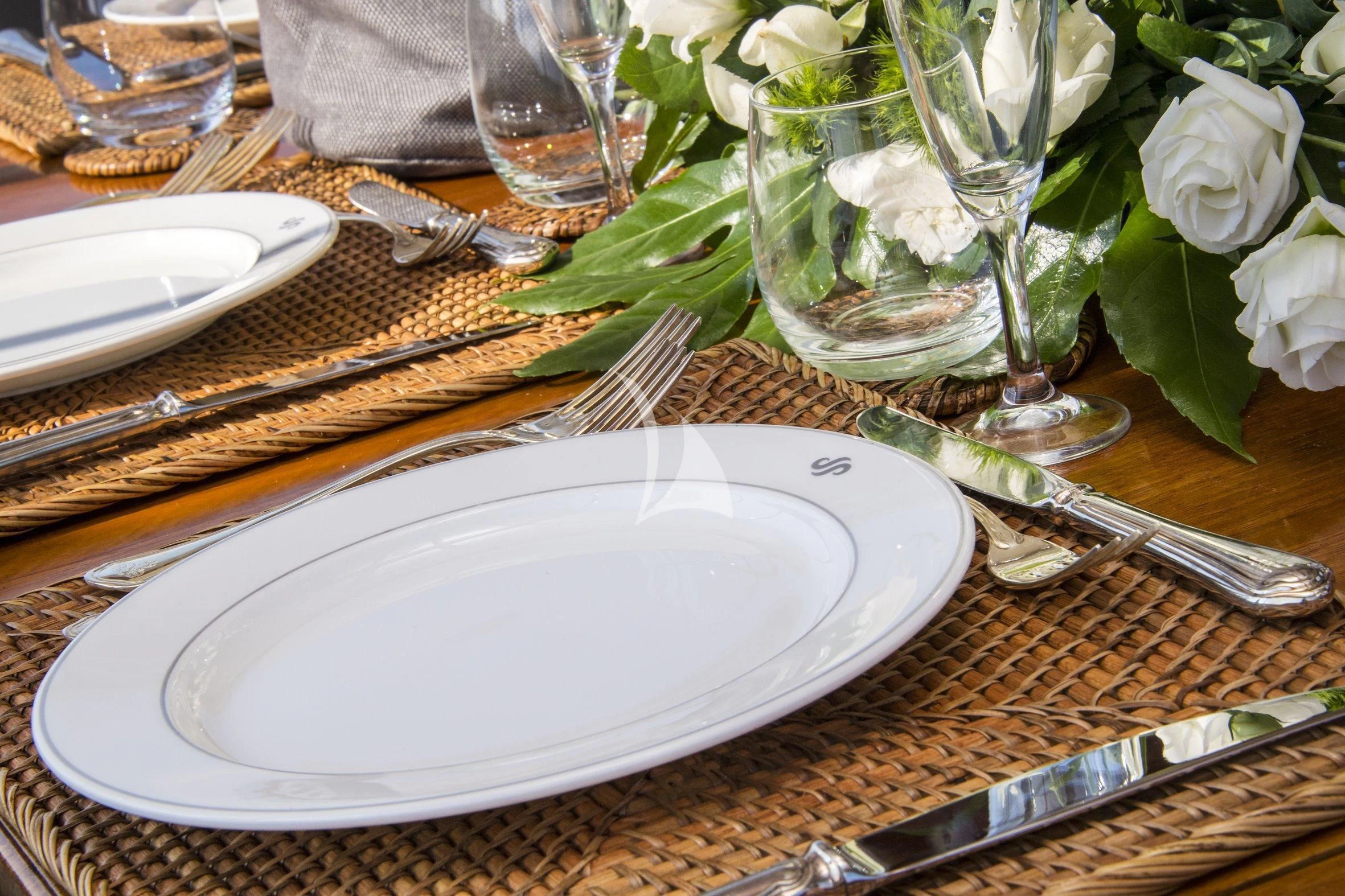 a table with plates and glasses aboard SEA PRINCE Yacht for Sale