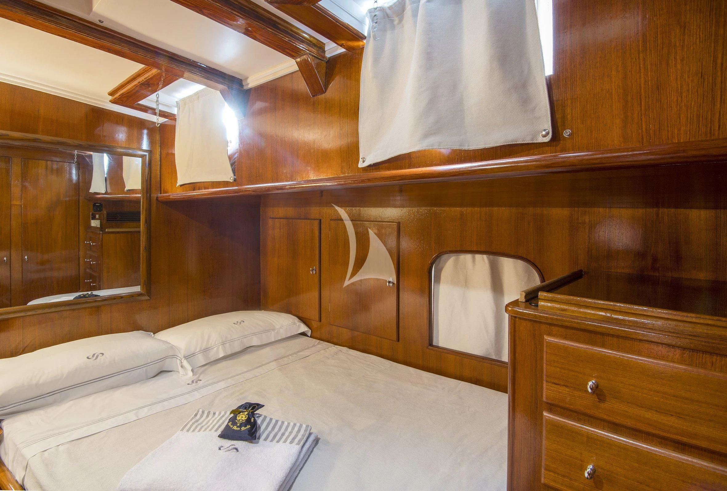 a bed with a mirror above it aboard SEA PRINCE Yacht for Sale