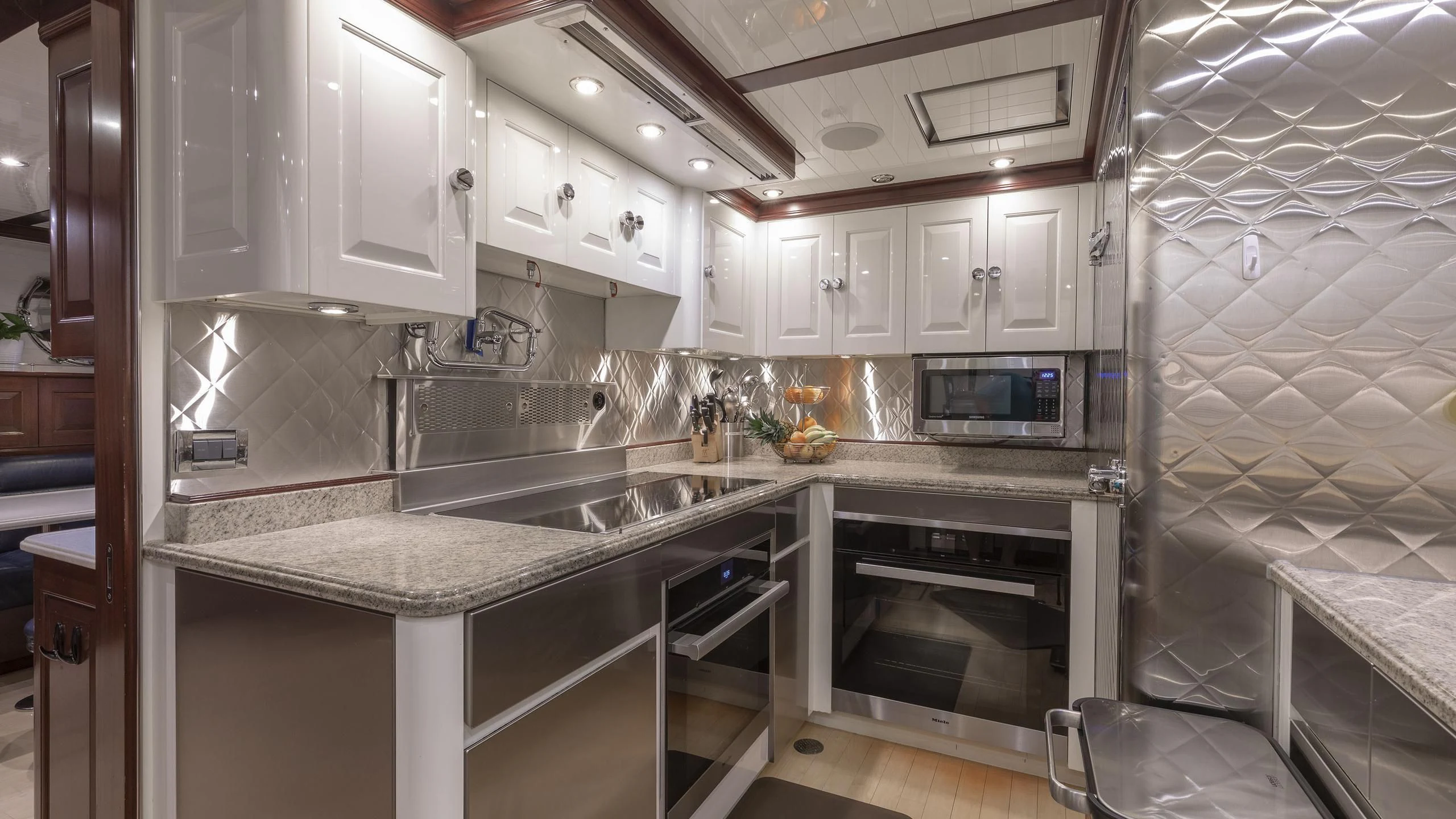 a kitchen with white cabinets aboard NADAN Yacht for Sale