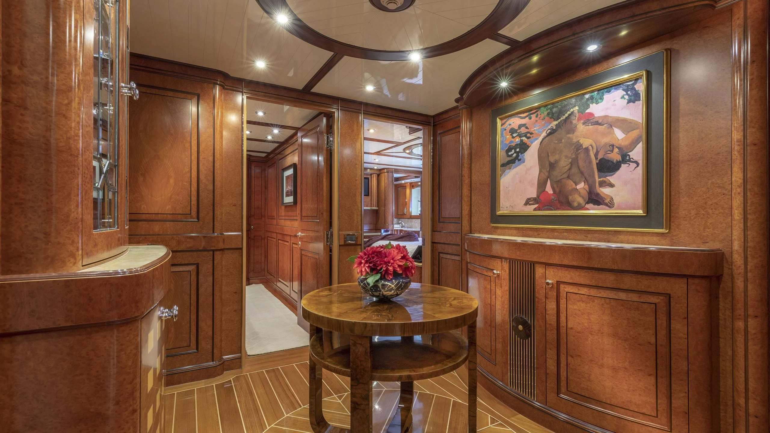 a room with a table and a painting on the wall aboard NADAN Yacht for Sale