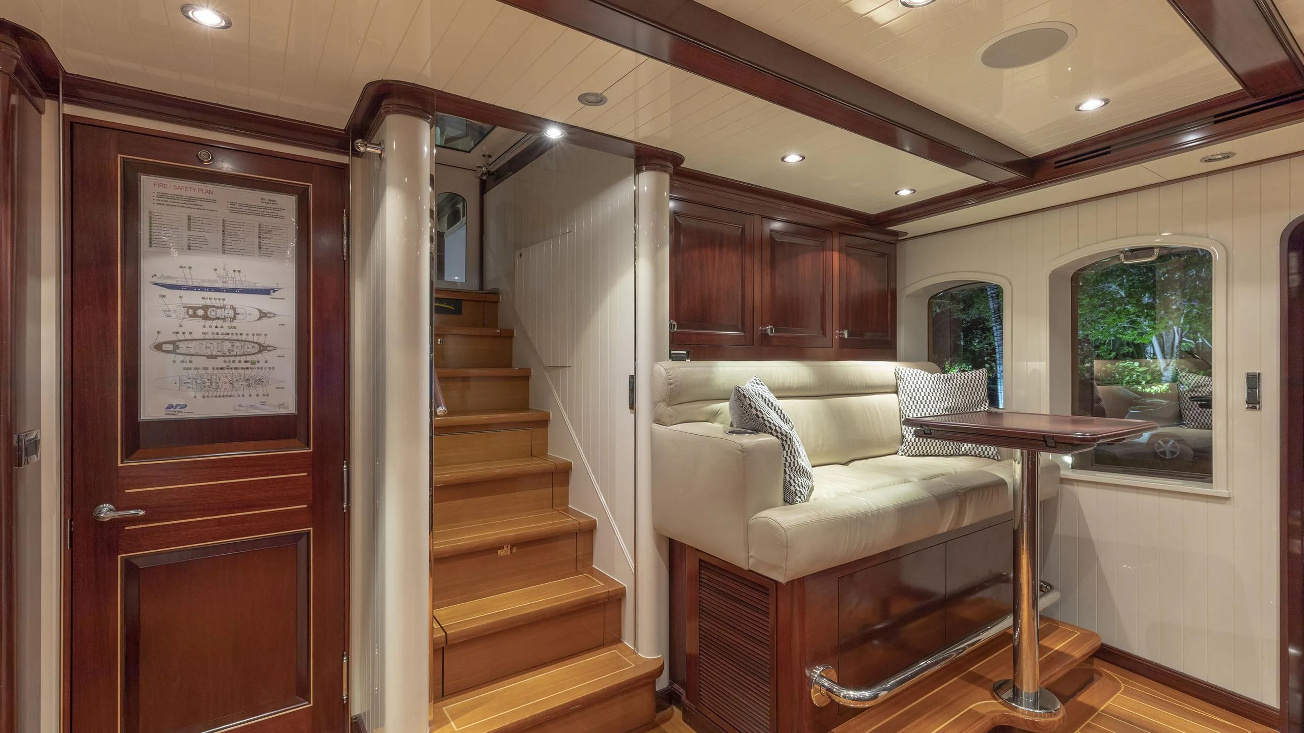 a room with a couch and a table and a chair aboard NADAN Yacht for Sale