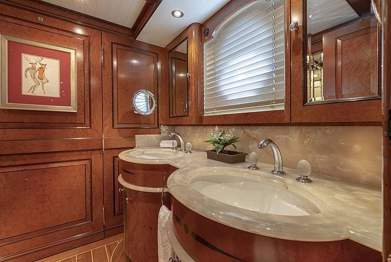 a bathroom with wooden cabinets aboard NADAN Yacht for Sale