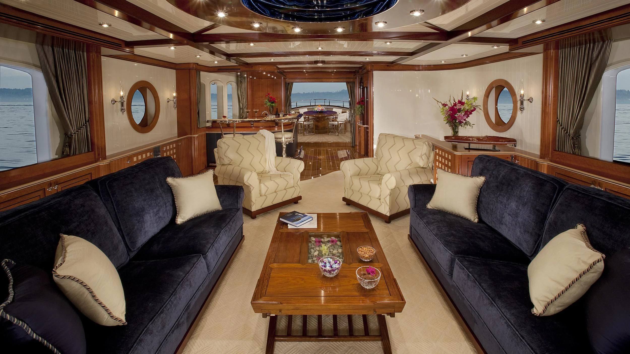 a living room with leather couches and a coffee table aboard NADAN Yacht for Sale