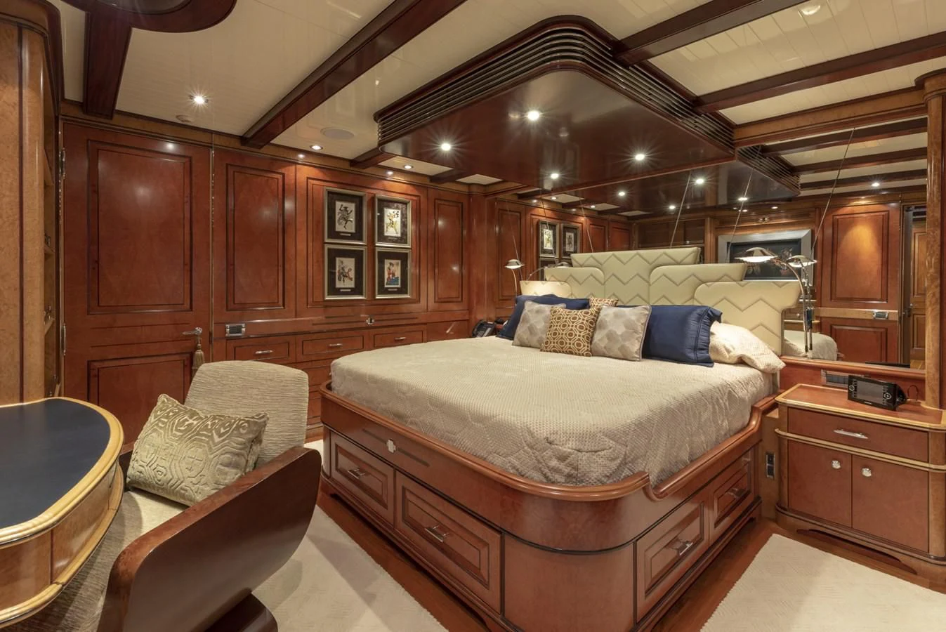 a bedroom with a bed and a chair aboard NADAN Yacht for Sale