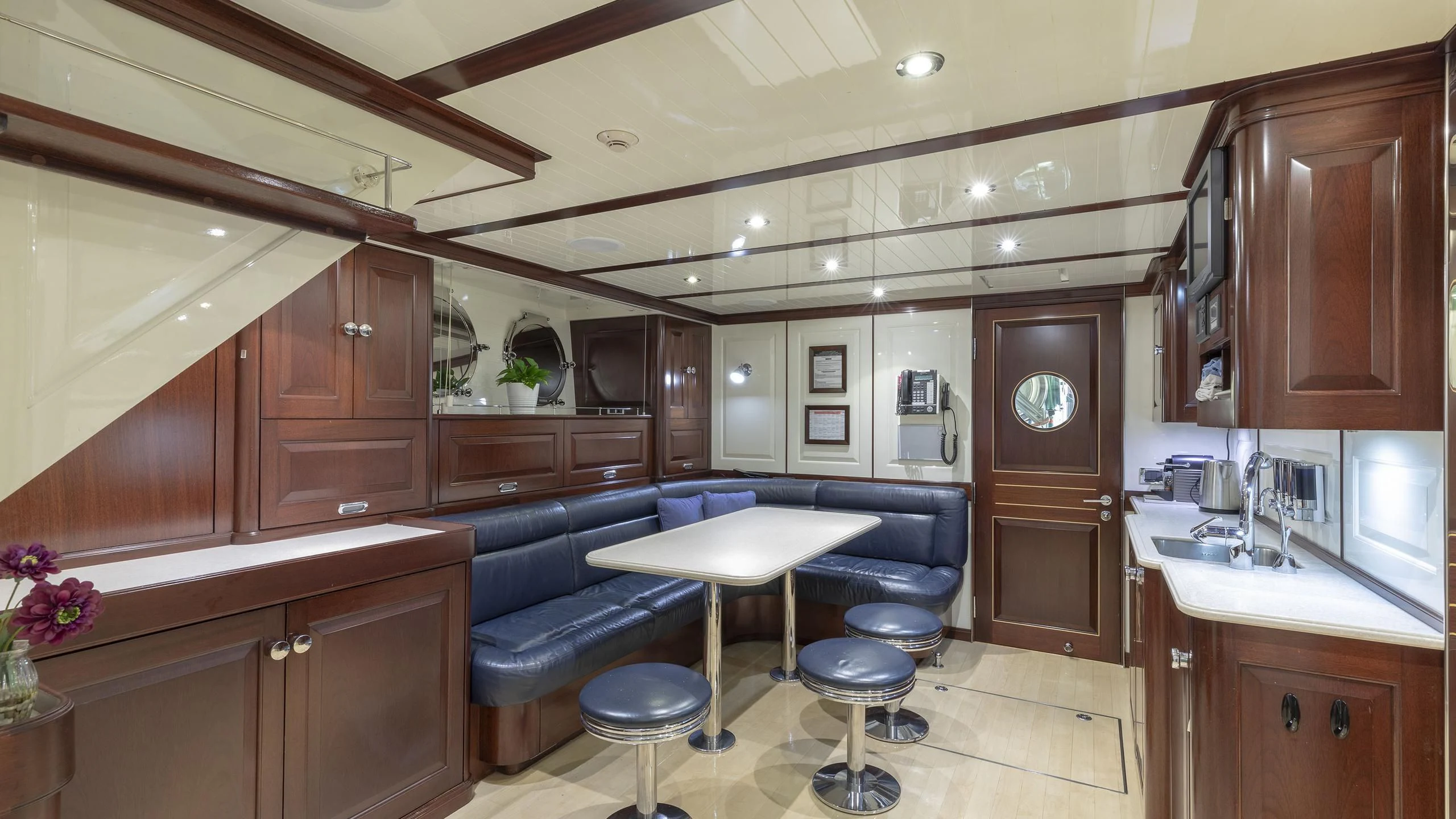 a kitchen with a dining table aboard NADAN Yacht for Sale