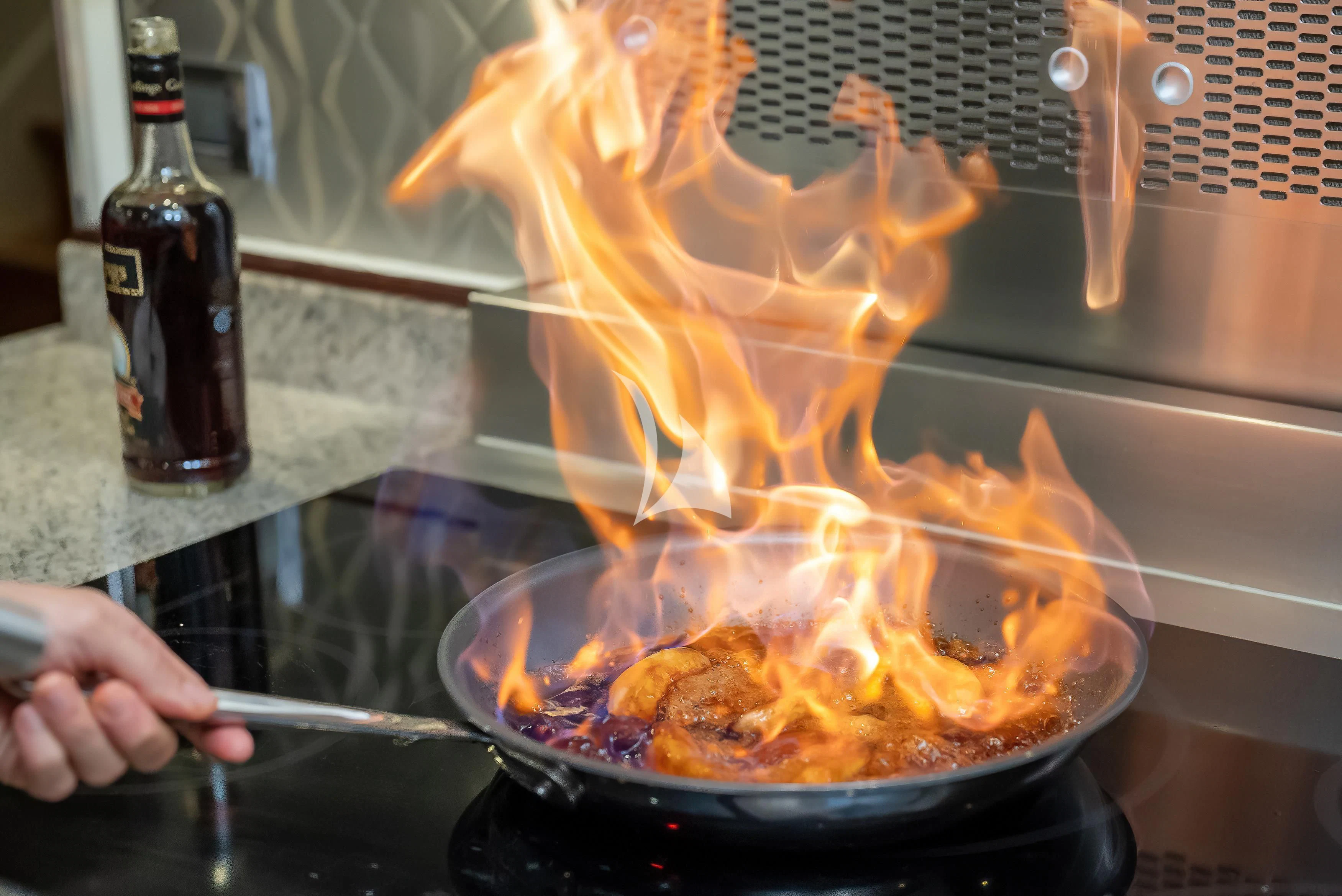 a person cooking on a stove aboard NADAN Yacht for Sale