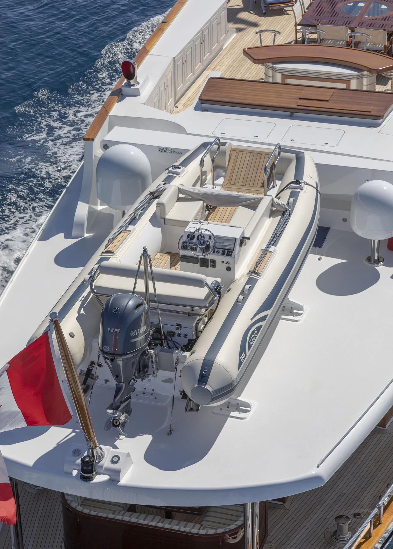 a white boat with a red and black sail on the front aboard NADAN Yacht for Sale