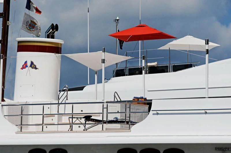 a boat with a flag and an umbrella on it aboard NADAN Yacht for Sale