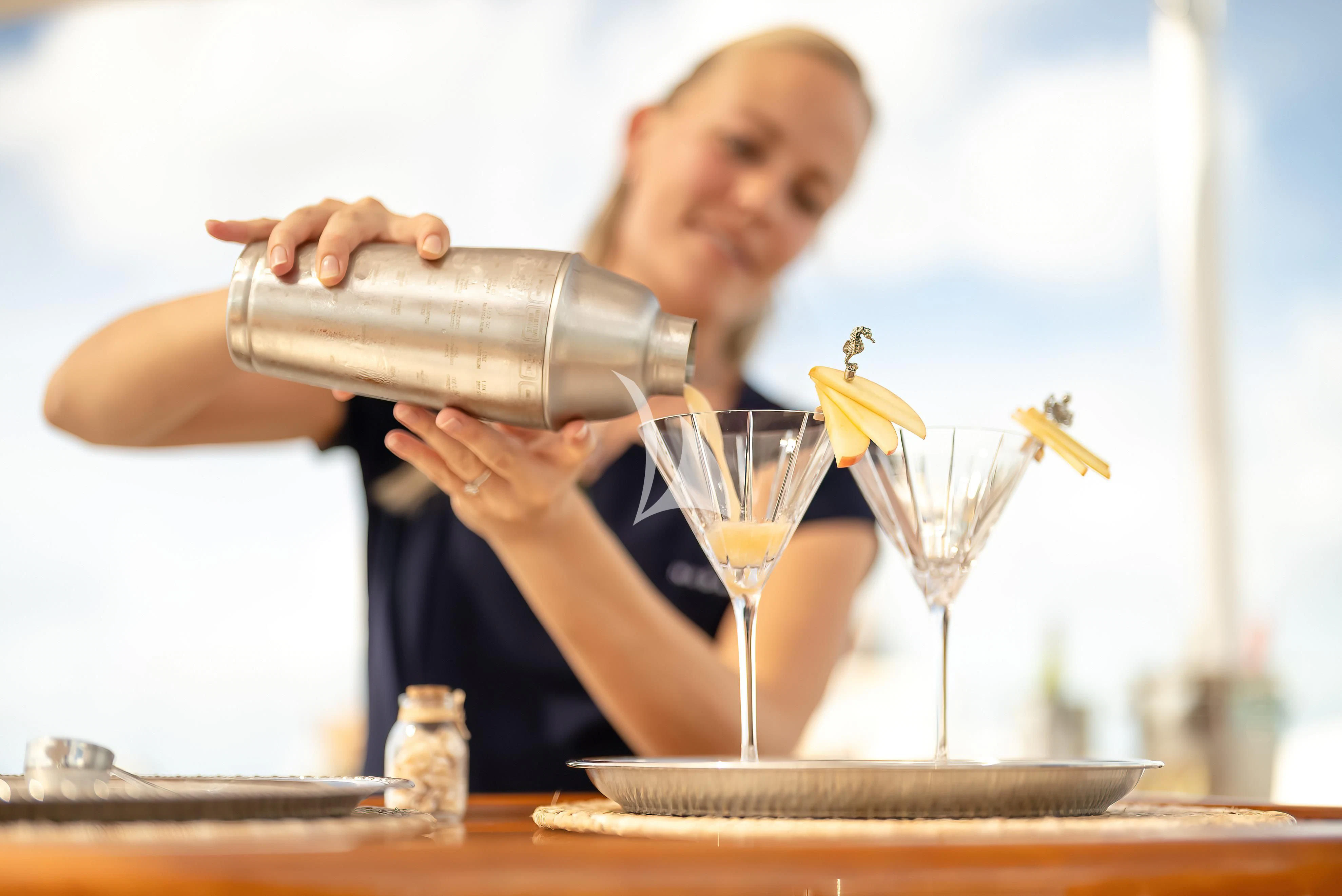 a person pouring a glass of wine aboard NADAN Yacht for Sale
